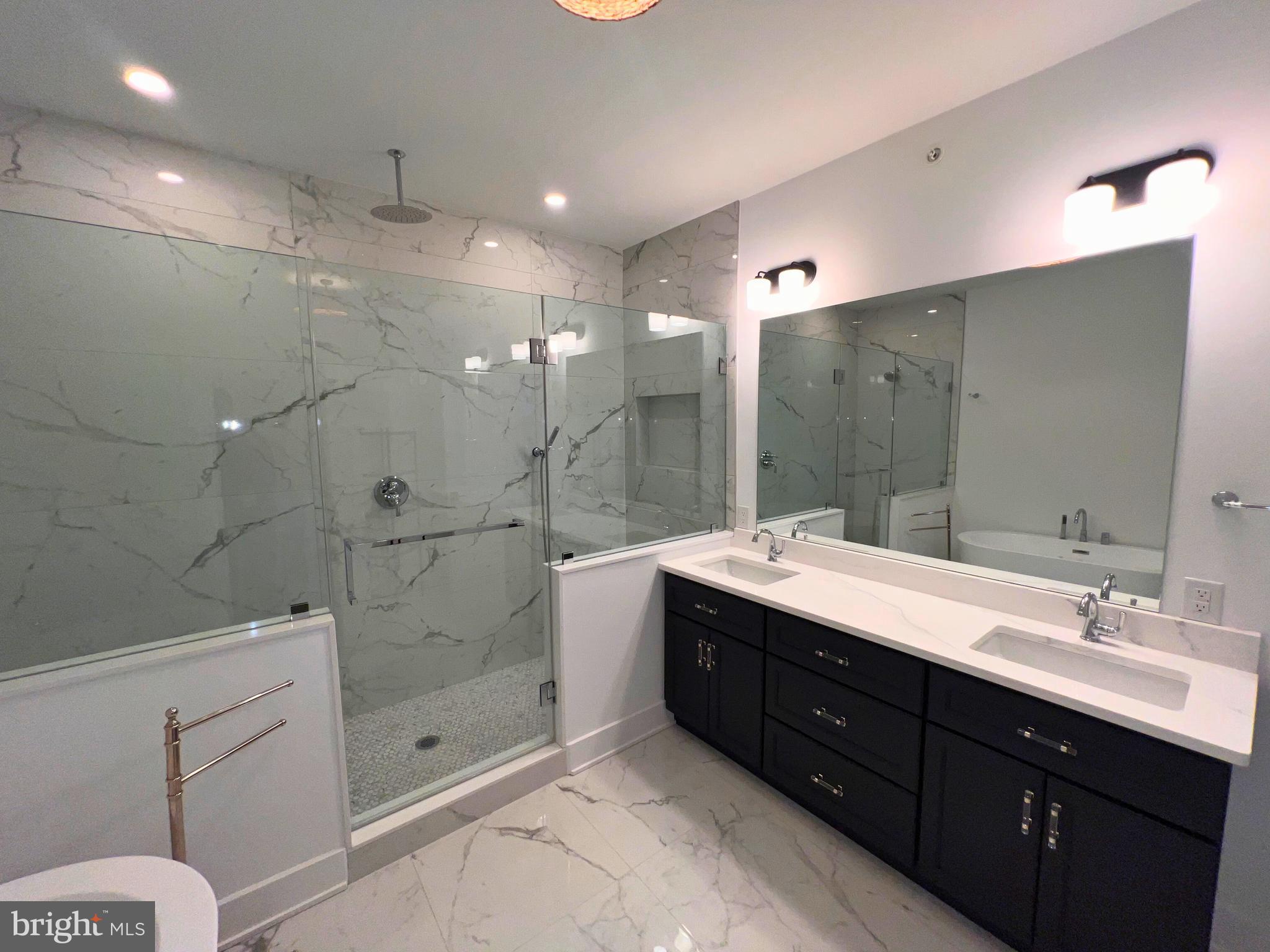 986 Henry Avenue Wayne, PA 19087 - Photo 16 of 32 a bathroom with a double vanity sink mirror and shower