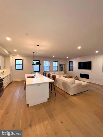 a spacious bedroom with a bed and a flat screen tv