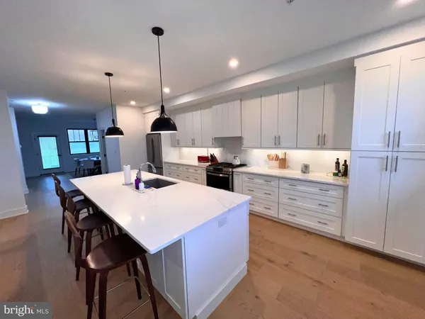 a kitchen with granite countertop white cabinets and stainless steel appliances