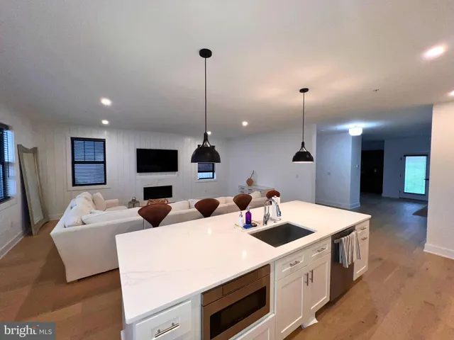 a spacious bedroom with a large bed and a flat screen tv