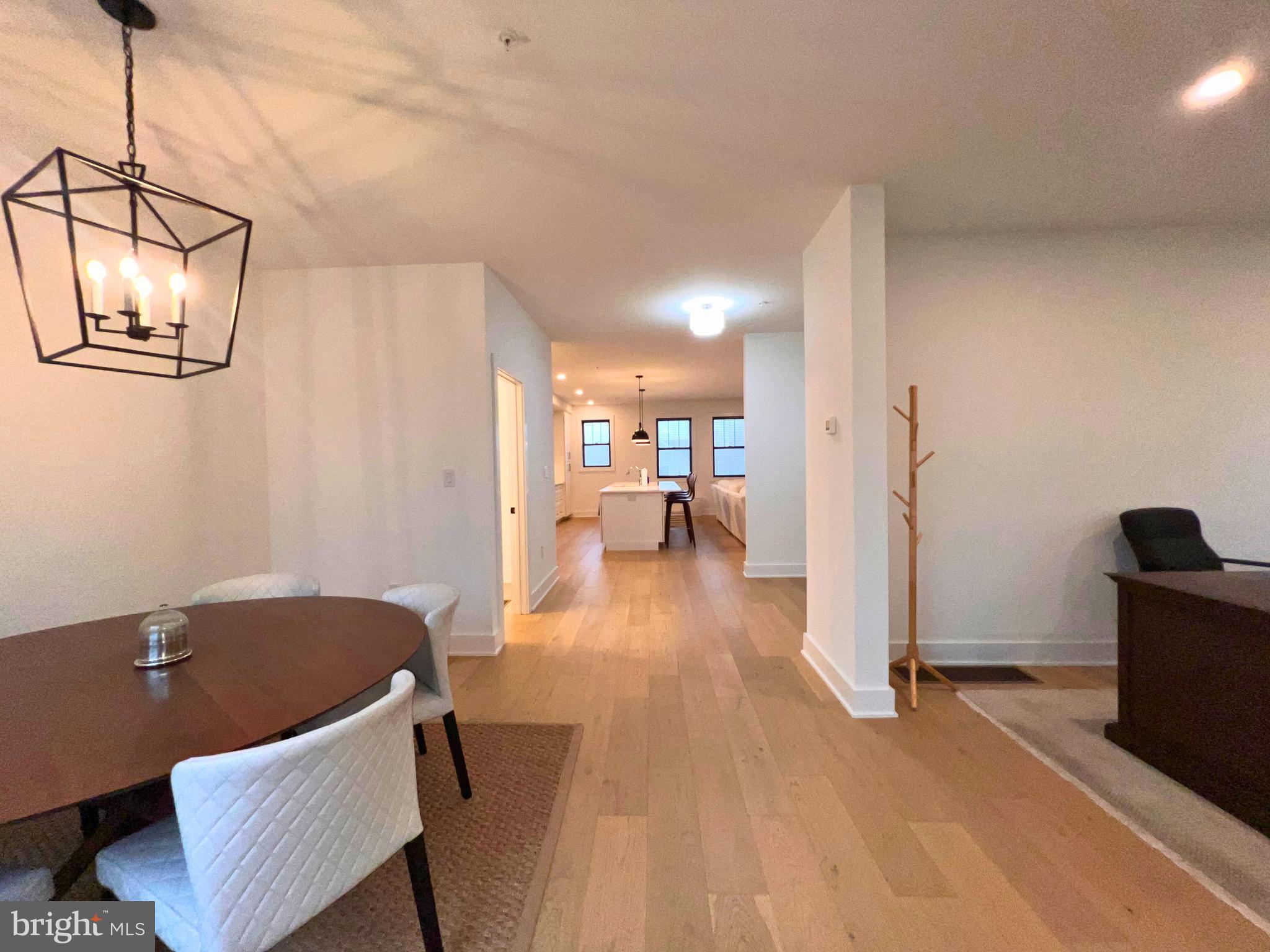 986 Henry Avenue Wayne, PA 19087 - Photo 10 of 32 a view of a livingroom with furniture a dinning room and wooden floor