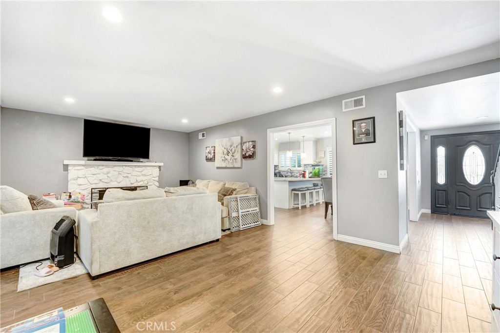 11800 Gager Street Sylmar, CA 91342 - Photo 11 of 25 a living room with furniture and a flat screen tv