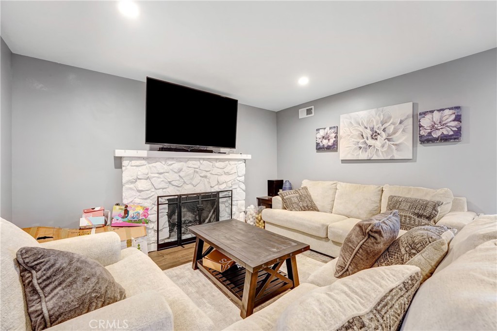 11800 Gager Street Sylmar, CA 91342 - Photo 12 of 25 a living room with furniture a flat screen tv and a fireplace
