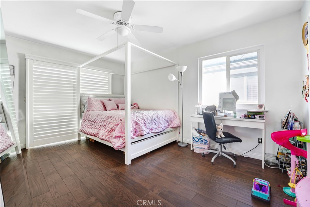 11800 Gager Street Sylmar, CA 91342 - Photo 16 of 25 a bedroom with a bed a desk and chair with the wooden floor