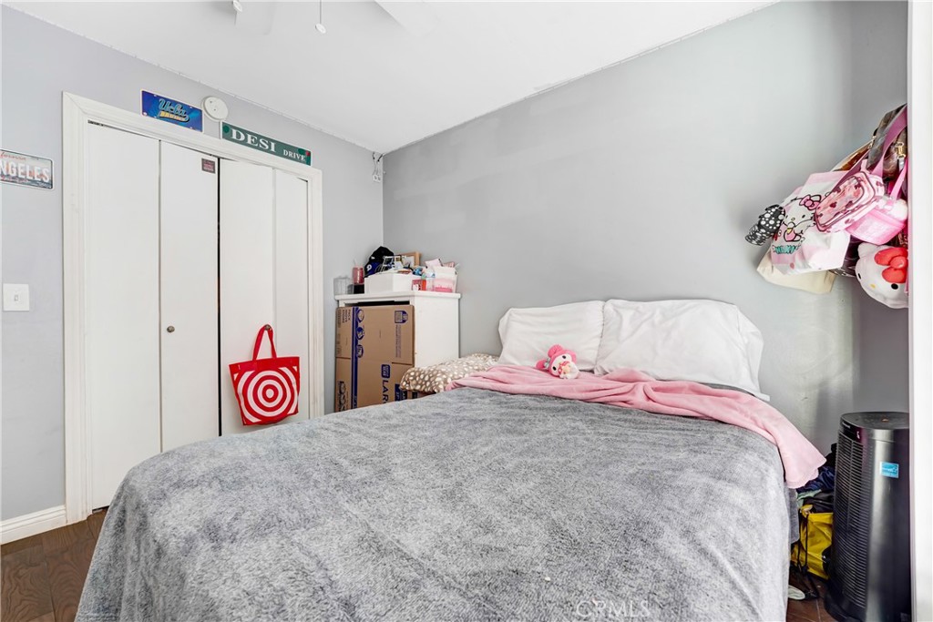 11800 Gager Street Sylmar, CA 91342 - Photo 17 of 25 a bedroom with a bed and a plant