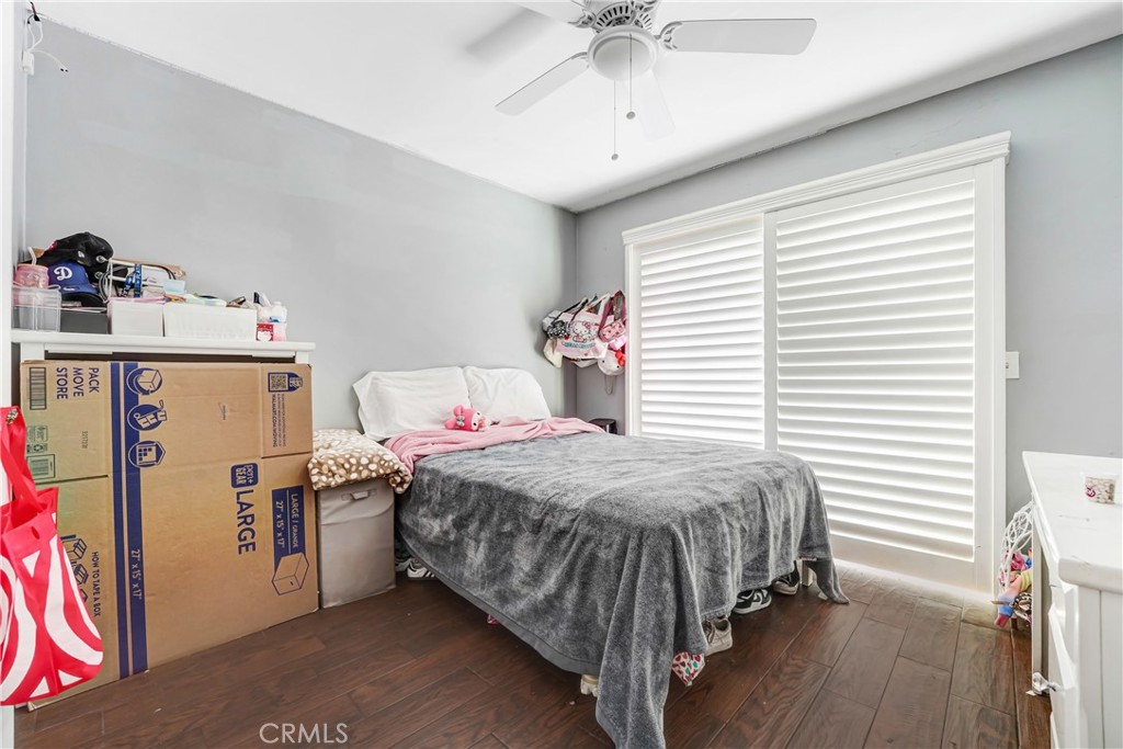 11800 Gager Street Sylmar, CA 91342 - Photo 18 of 25 a bedroom with a bed and a chandelier