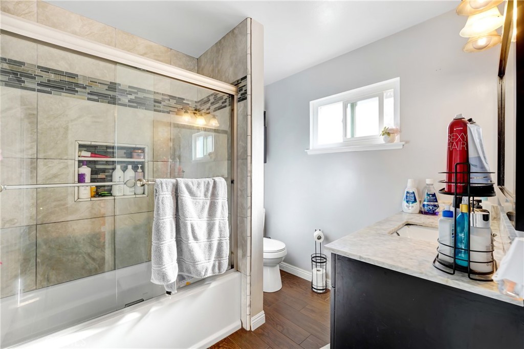 11800 Gager Street Sylmar, CA 91342 - Photo 20 of 25 a bathroom with a shower sink and toilet