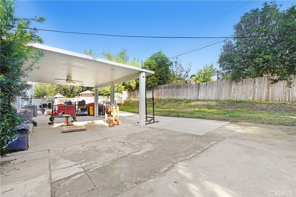 11800 Gager Street Sylmar, CA 91342 - Photo 5 of 25 a view of a patio with a table and chairs under an umbrella
