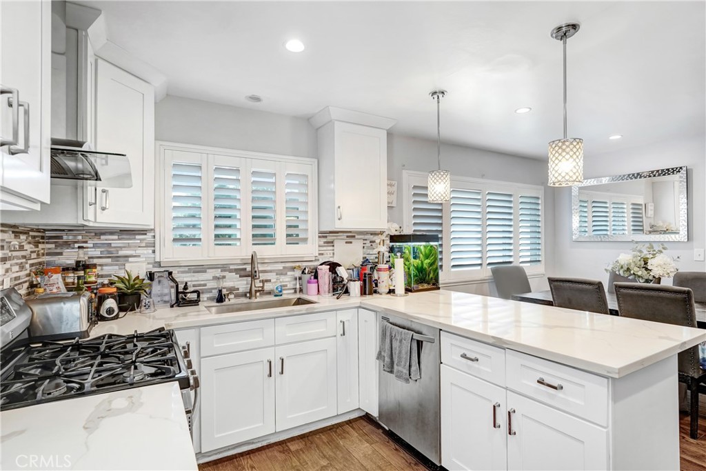 11800 Gager Street Sylmar, CA 91342 - Photo 8 of 25 a kitchen with a sink stove and cabinets