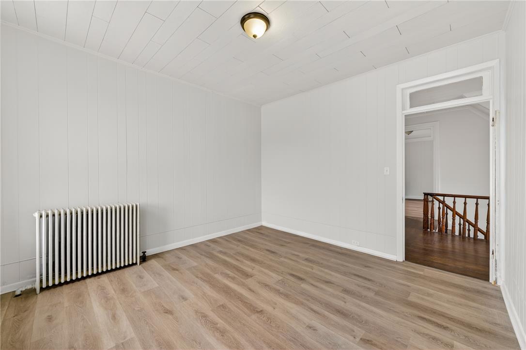 65 2nd Street Slatington, PA 18080 - Photo 30 of 46 This naturally illuminated room features light wood plank flooring and a classic radiator, offering a comfortable space.