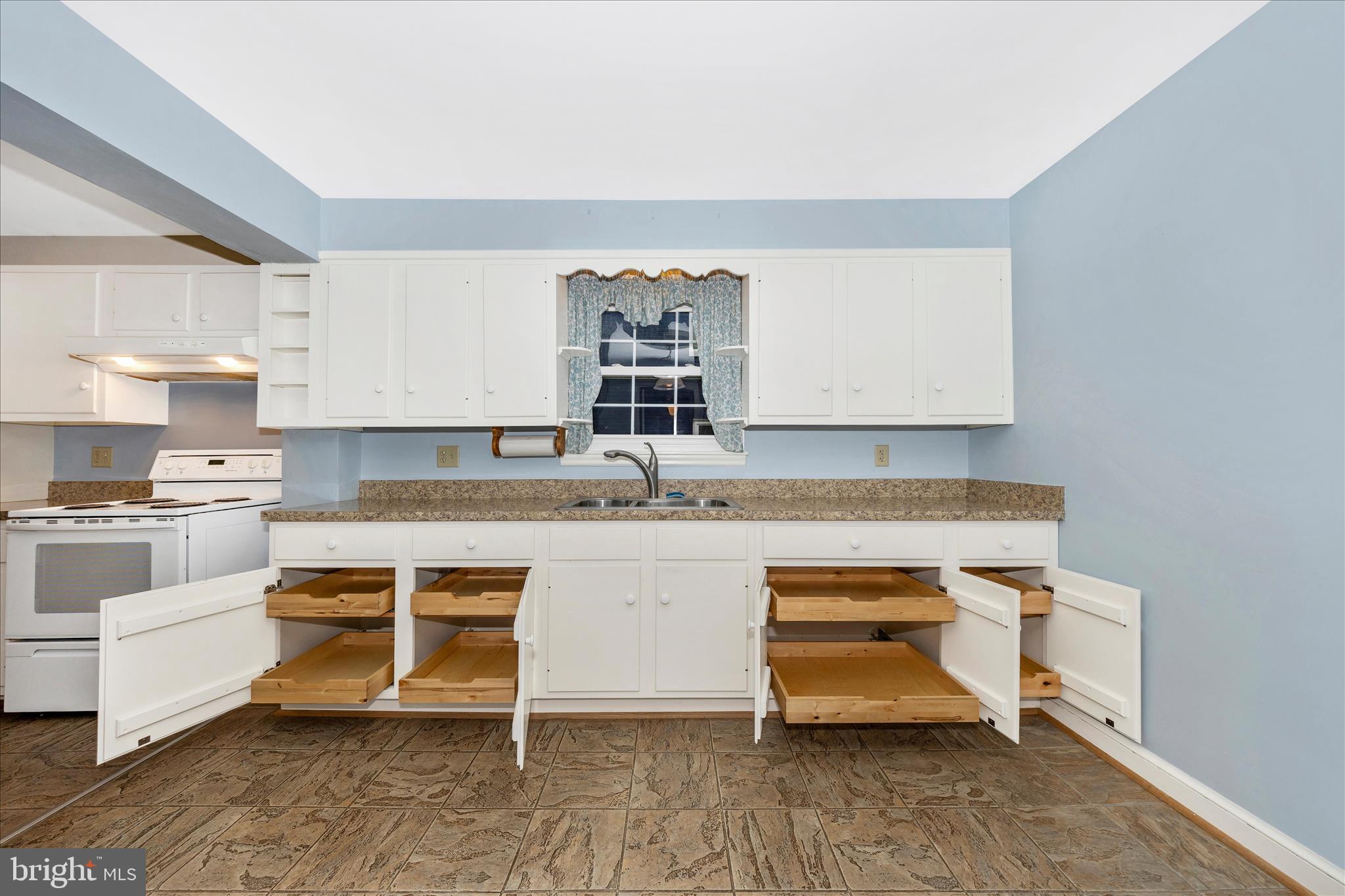9 East 13th Street Frederick, MD 21701 - Photo 13 of 51 a kitchen with white cabinets and white appliances