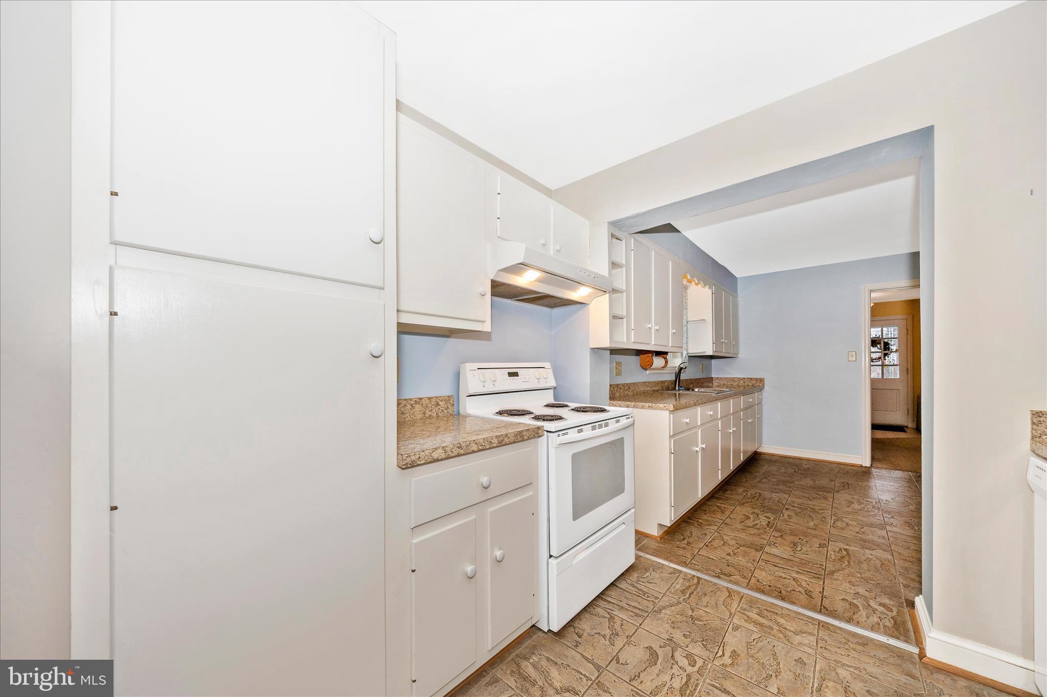 9 East 13th Street Frederick, MD 21701 - Photo 16 of 51 a kitchen with white cabinets and white appliances