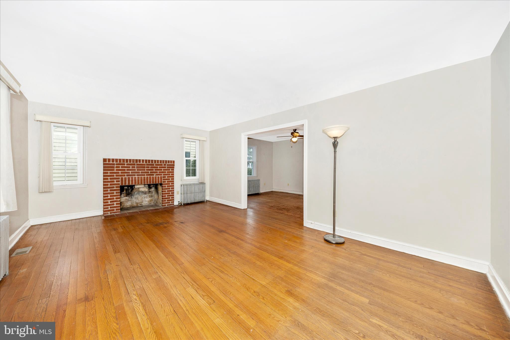 9 East 13th Street Frederick, MD 21701 - Photo 9 of 51 an empty room with wooden floor and fireplace