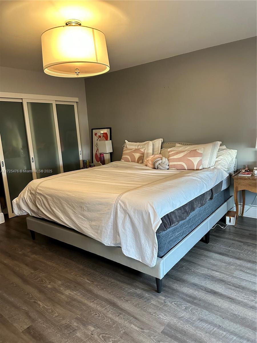 2333 Brickell Avenue, Unit 2116 Miami, FL 33129 - Photo 12 of 32 a bedroom with a bed and a wooden floor