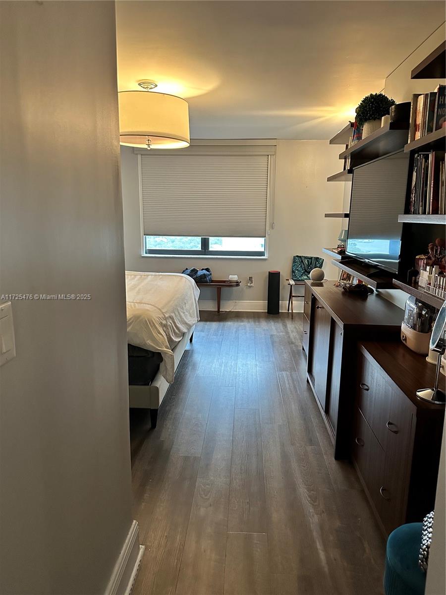 2333 Brickell Avenue, Unit 2116 Miami, FL 33129 - Photo 16 of 32 a bed room with a bed and a book shelf