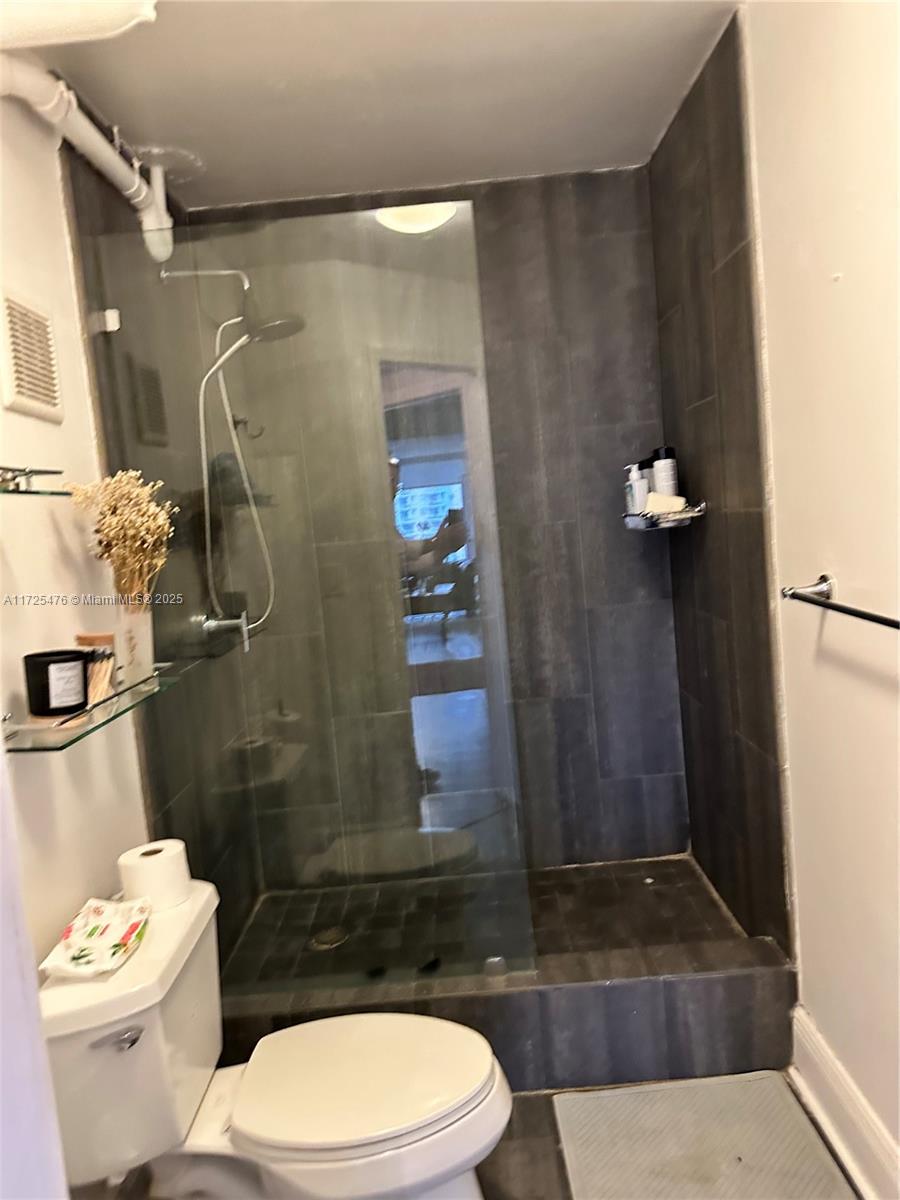 2333 Brickell Avenue, Unit 2116 Miami, FL 33129 - Photo 22 of 32 a bathroom with a toilet a sink and shower