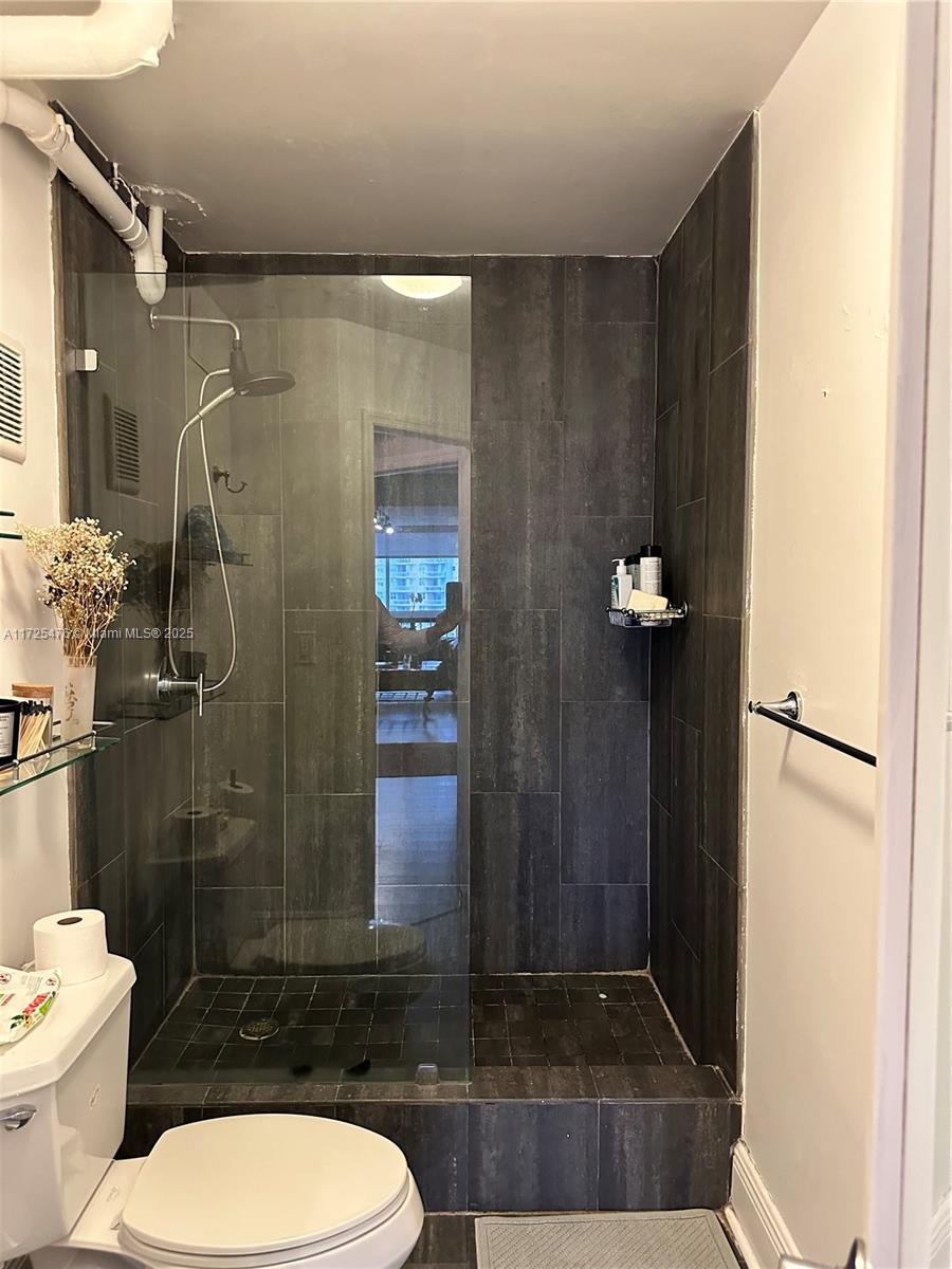 2333 Brickell Avenue, Unit 2116 Miami, FL 33129 - Photo 23 of 32 a bathroom with a toilet a sink and shower