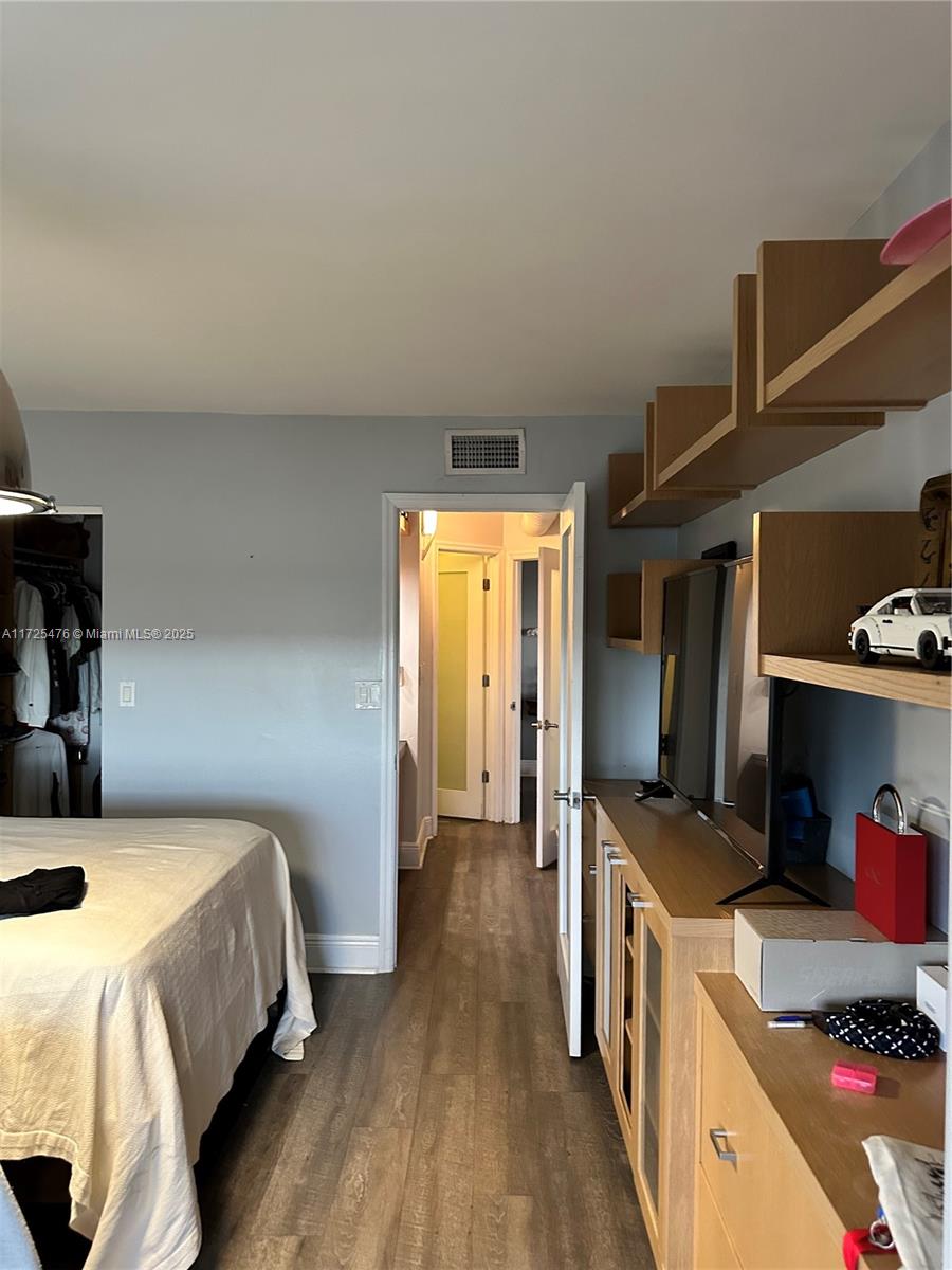 2333 Brickell Avenue, Unit 2116 Miami, FL 33129 - Photo 29 of 32 a bedroom with a bed and a tv