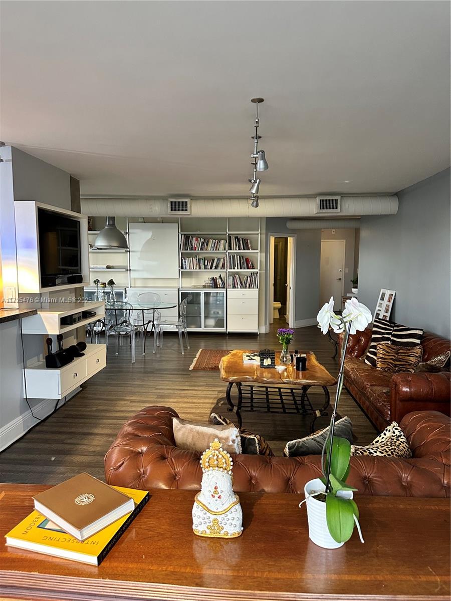 2333 Brickell Avenue, Unit 2116 Miami, FL 33129 - Photo 10 of 32 a room with lots of white furniture and a wooden floor