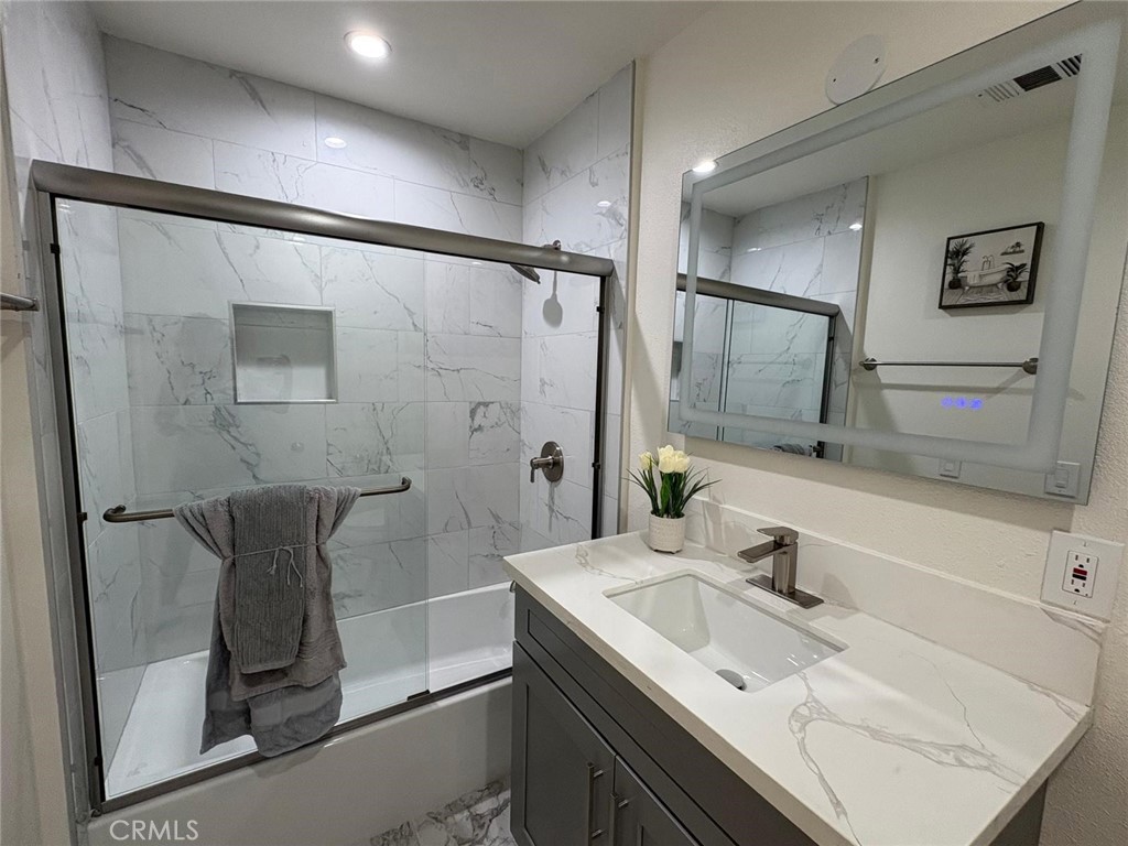 810 West Compton Boulevard, Unit 9 Compton, CA 90220 - Photo 12 of 16 a bathroom with a granite countertop sink a shower and a mirror