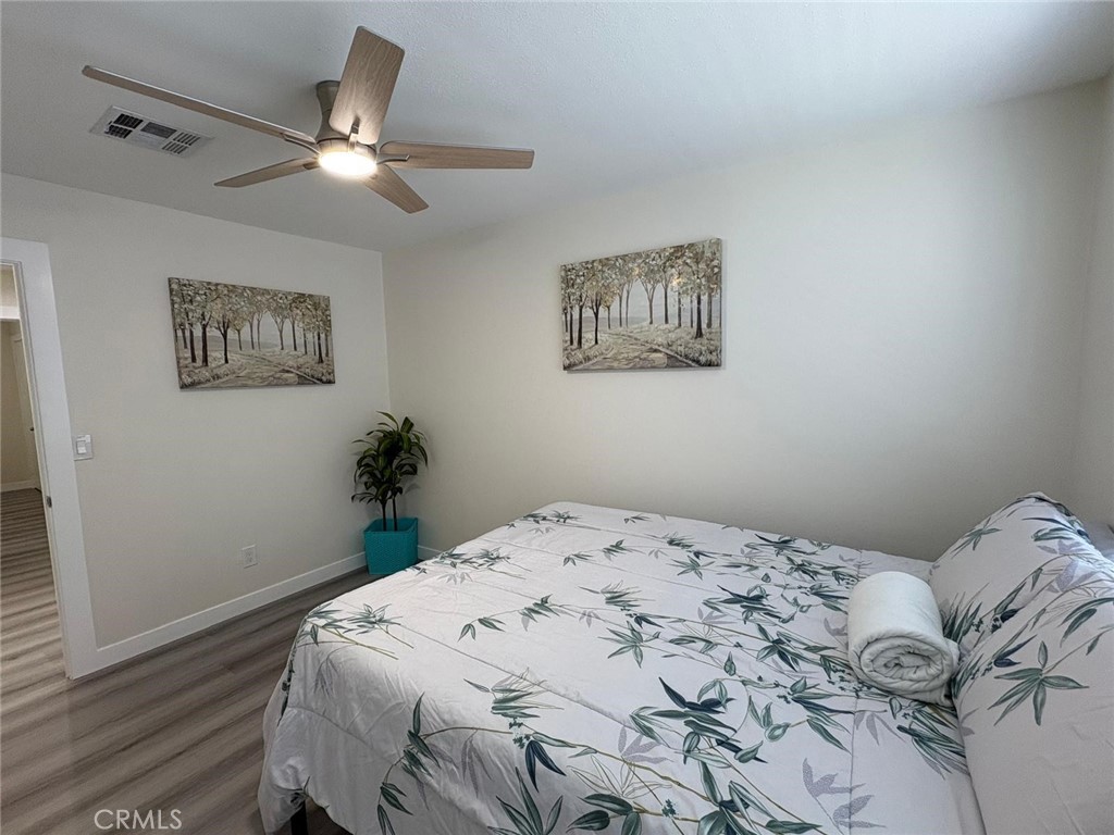 810 West Compton Boulevard, Unit 9 Compton, CA 90220 - Photo 15 of 16 a bedroom with a bed and a painting on the wall