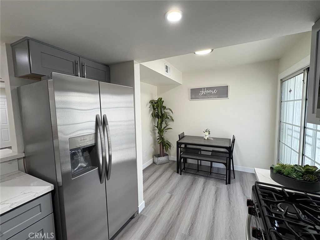810 West Compton Boulevard, Unit 9 Compton, CA 90220 - Photo 5 of 16 a kitchen with a refrigerator and a table