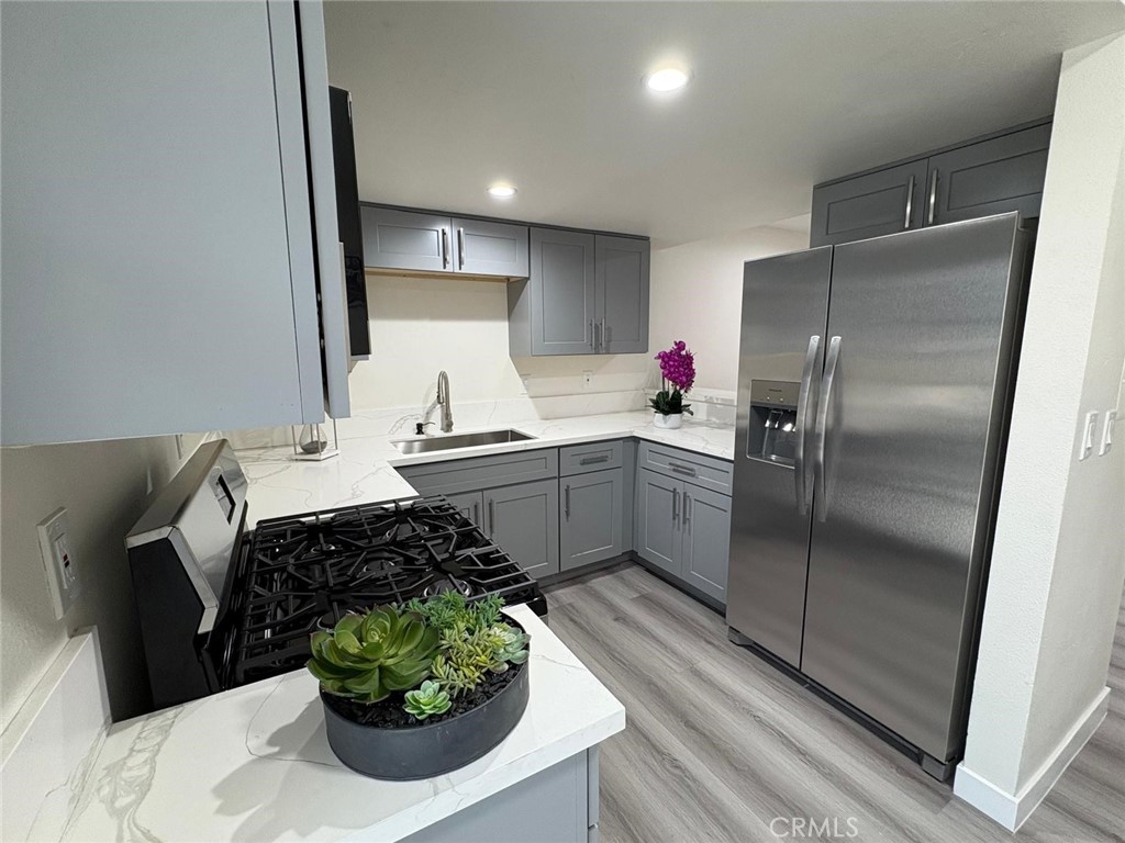 810 West Compton Boulevard, Unit 9 Compton, CA 90220 - Photo 8 of 16 a kitchen with stainless steel appliances kitchen island granite countertop a refrigerator a sink a stove and a refrigerator