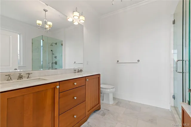 a bathroom with a granite countertop sink a toilet and a mirror