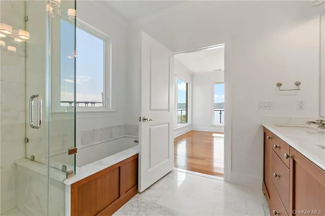 a bathroom with a tub shower and sink