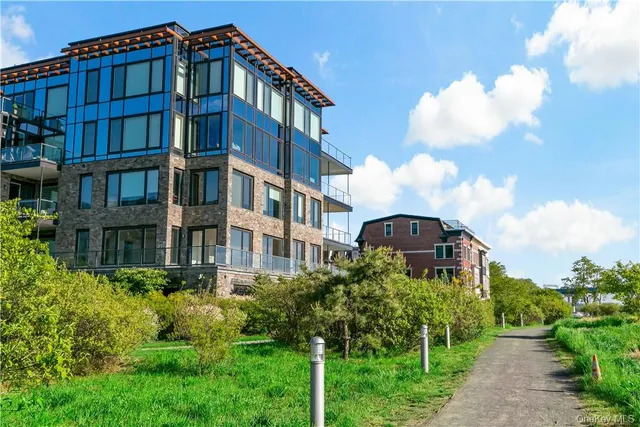 a view of a brick building next to a big yard