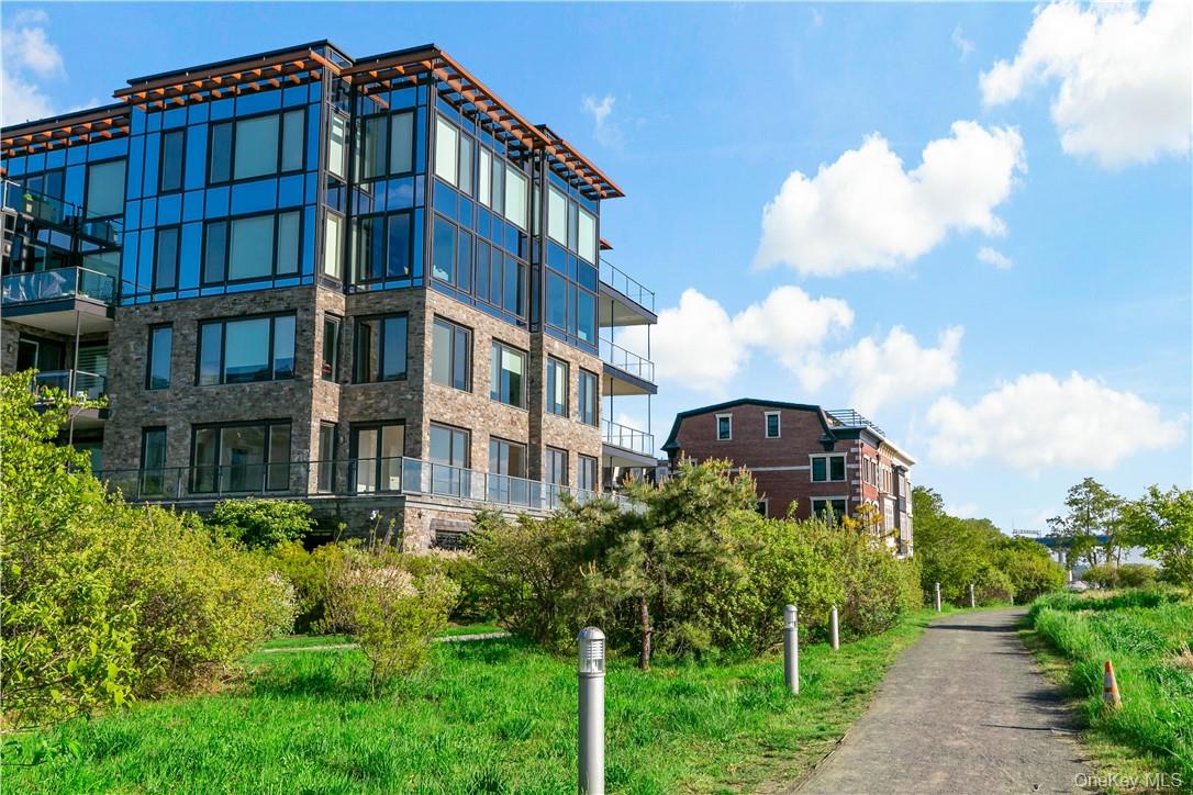 16 Rivers Edge Drive, Unit 200 Tarrytown, NY 10591 - Photo 18 of 19 a view of a brick building next to a yard