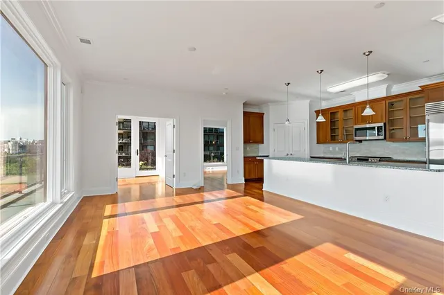 a swimming pool with large glass windows and painted walls