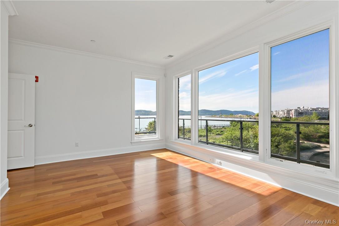 16 Rivers Edge Drive, Unit 200 Tarrytown, NY 10591 - Photo 10 of 19 an empty room with wooden floor and windows