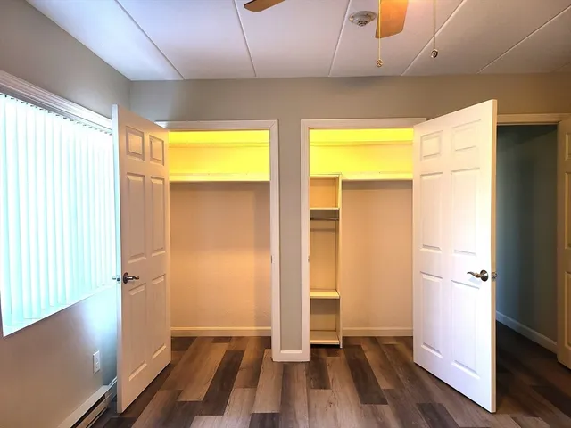a view of a room with wooden floor and a window