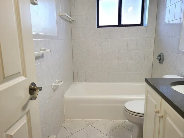 a bathroom with a sink a toilet and bathtub