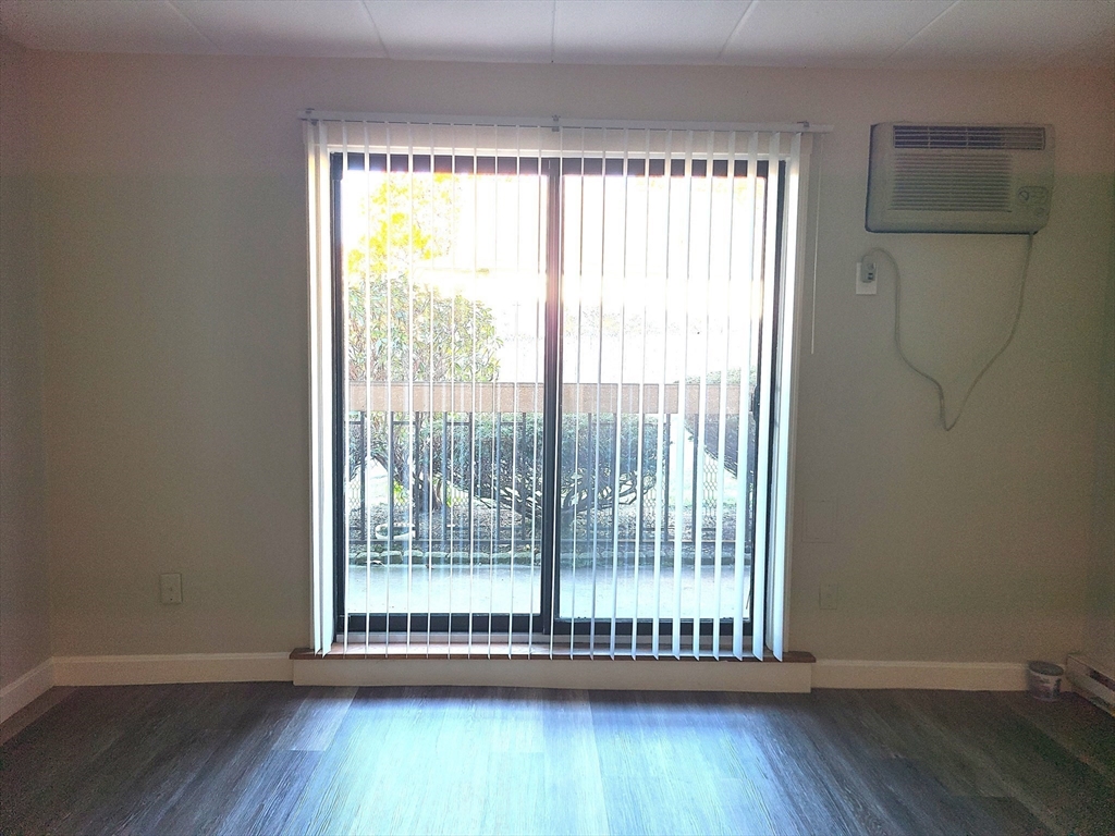 576 Washington Street, Unit 114 Weymouth, MA 02188 - Photo 6 of 24 a view of a room with wooden floor and a window
