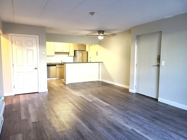 a view of a kitchen with wooden floor and a sink