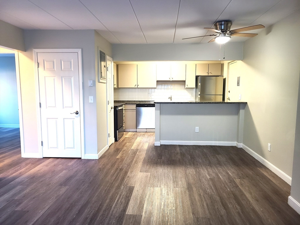 576 Washington Street, Unit 114 Weymouth, MA 02188 - Photo 8 of 24 a view of a kitchen with a dishwasher and wooden floor