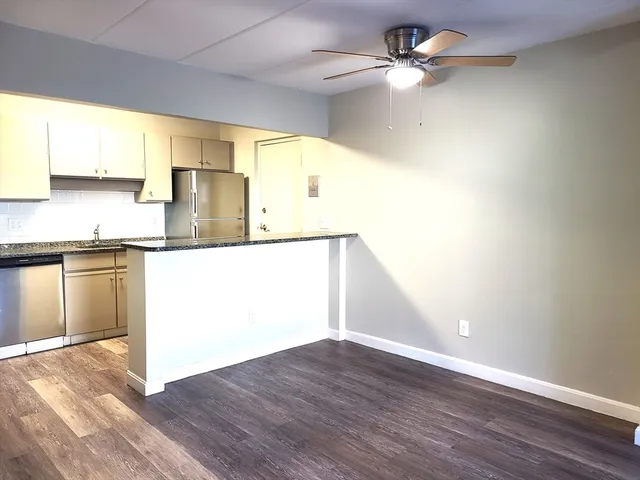 a view interior of a kitchen with wooden floor a sink and a window