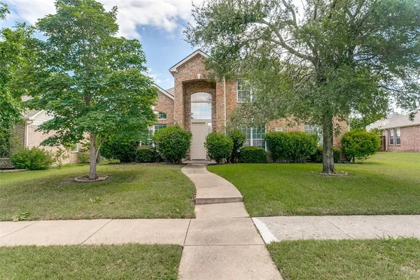front view of a house with a yard