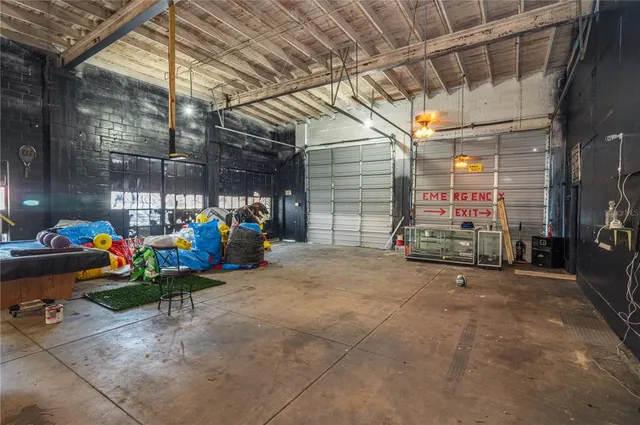 a view of a kitchen with refrigerator and dining table