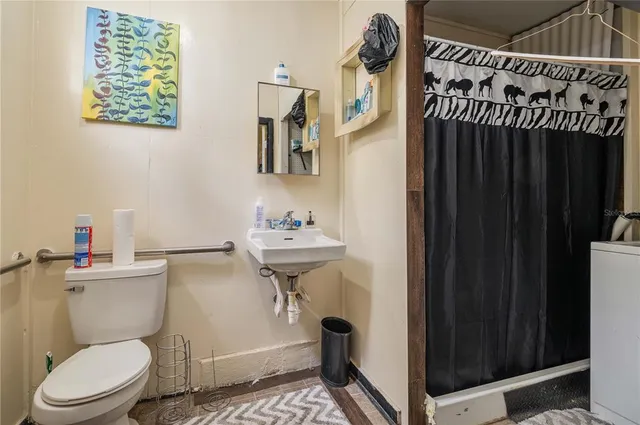 a bathroom with a sink a mirror and a shower