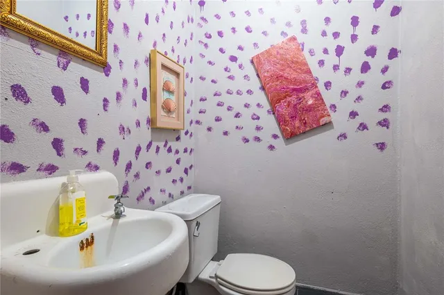a view of a dining room with furniture a rug and wooden floor