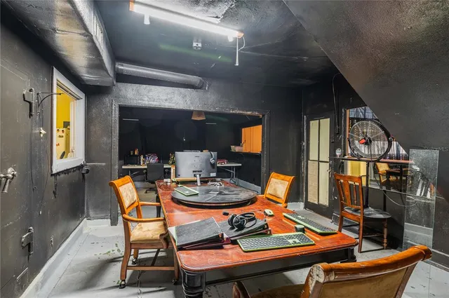 a room with a window and a ceiling fan