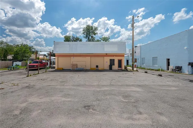 a view of a house with a backyard and a car