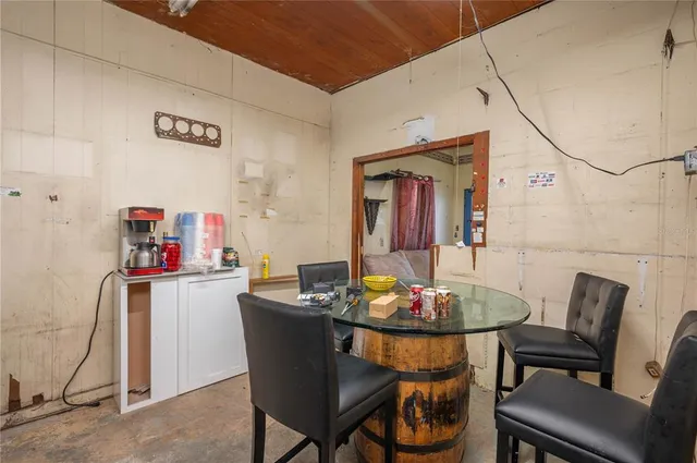 a backyard of a house with table and chairs