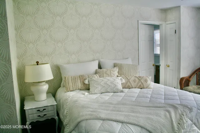 a bedroom with a bed and a lamp