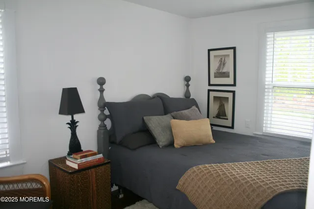 a bedroom with furniture and a window