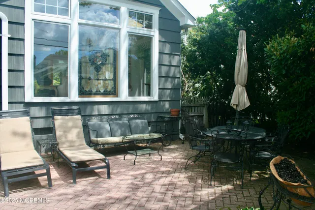 a view of backyard with outdoor seating and plants