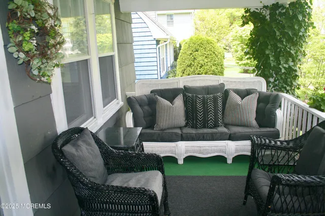 a balcony with furniture and a garden